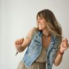 Smiling woman enjoying a dance, expressing joy and freedom inside.